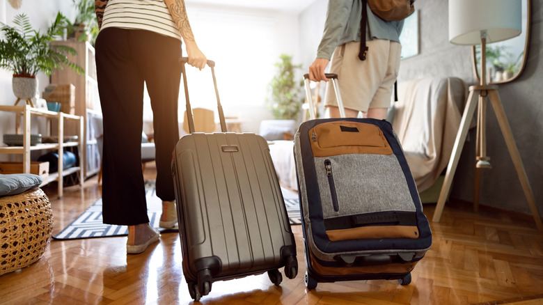 couple with luggage entering airbnb